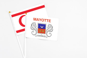 Mayotte and Northern Cyprus stick flags on white background. High quality fabric, miniature national flag. Peaceful global concept.White floor for copy space.