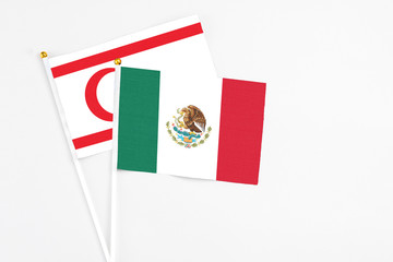 Mexico and Northern Cyprus stick flags on white background. High quality fabric, miniature national flag. Peaceful global concept.White floor for copy space.