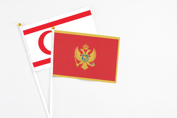 Montenegro and Northern Cyprus stick flags on white background. High quality fabric, miniature national flag. Peaceful global concept.White floor for copy space.