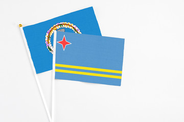 Aruba and Northern Mariana Islands stick flags on white background. High quality fabric, miniature national flag. Peaceful global concept.White floor for copy space.