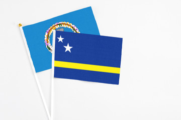 Curacao and Northern Mariana Islands stick flags on white background. High quality fabric, miniature national flag. Peaceful global concept.White floor for copy space.