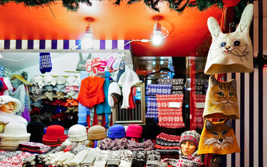 Wool mittens, gloves, socks and hats on stalls at Christmas market in Riga in Latvia winter. Street Xmas and holiday fair in European city or town. Advent Decoration with Crafts Items on Bazaar