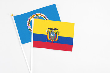 Ecuador and Northern Mariana Islands stick flags on white background. High quality fabric, miniature national flag. Peaceful global concept.White floor for copy space.