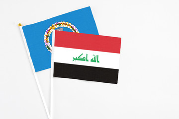 Iraq and Northern Mariana Islands stick flags on white background. High quality fabric, miniature national flag. Peaceful global concept.White floor for copy space.