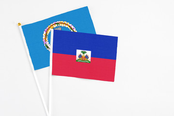 Haiti and Northern Mariana Islands stick flags on white background. High quality fabric, miniature...