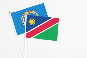 Namibia and Northern Mariana Islands stick flags on white background. High quality fabric, miniature national flag. Peaceful global concept.White floor for copy space.