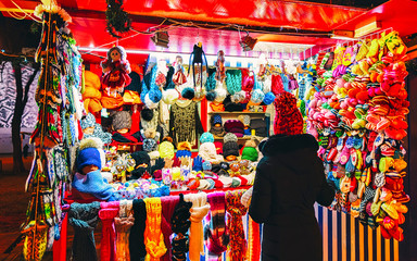 Knitted mittens, gloves, socks and hats on stalls at Christmas market in Riga of Latvia winter....