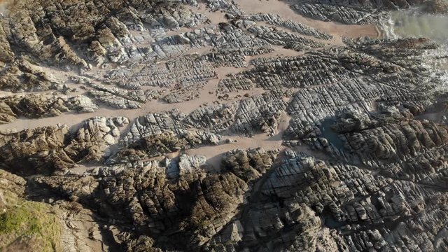 Aerial Landscape Flying Over Rocks And Beach Woolacombe, Devon, Bird's Eye View