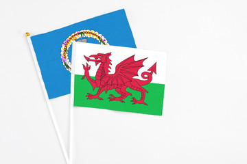 Wales and Northern Mariana Islands stick flags on white background. High quality fabric, miniature national flag. Peaceful global concept.White floor for copy space.
