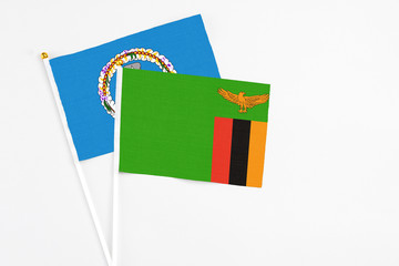 Zambia and Northern Mariana Islands stick flags on white background. High quality fabric, miniature national flag. Peaceful global concept.White floor for copy space.