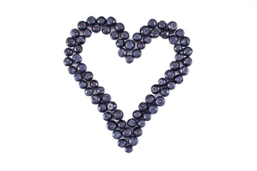 Heart made of huckleberry isolated on a white background.