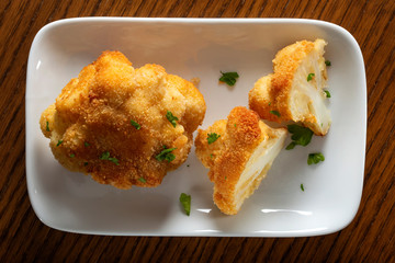Cauliflower fried on plate with chopped parsley