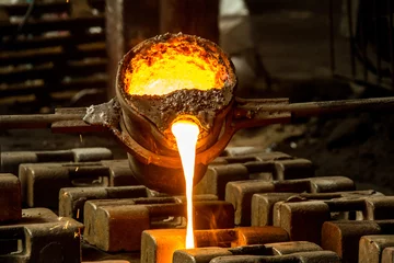 Fotobehang metal casting process with red high temperature fire in metal part factory © mehmetcan