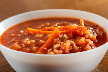 Tomato creamy soup with carrot and rice