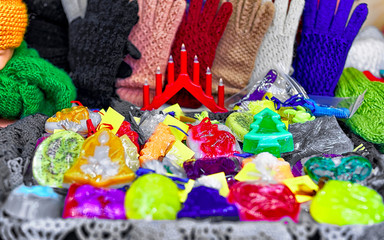 Handmade soap and Knitted gloves on stalls at Christmas market in Riga of Latvia winter. Street Xmas and holiday fair in European city or town. Advent Decoration with Crafts Items on Bazaar
