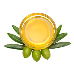 Olive oil. Greek olive oil in glass transparent bowl with three green olives and leaves in the form of a heraldic coat of arms. Close-up, Isolated on white background.