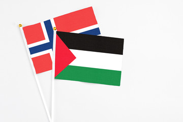 Palestine and Norway stick flags on white background. High quality fabric, miniature national flag....