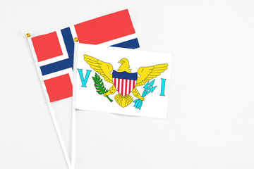 United States Virgin Islands and Norway stick flags on white background. High quality fabric, miniature national flag. Peaceful global concept.White floor for copy space.