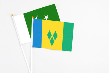 Saint Vincent And The Grenadines and Pakistan stick flags on white background. High quality fabric,...