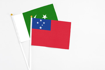 Samoa and Pakistan stick flags on white background. High quality fabric, miniature national flag. Peaceful global concept.White floor for copy space.