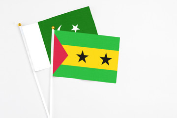 Sao Tome And Principe and Pakistan stick flags on white background. High quality fabric, miniature national flag. Peaceful global concept.White floor for copy space.