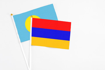 Armenia and Palau stick flags on white background. High quality fabric, miniature national flag. Peaceful global concept.White floor for copy space.