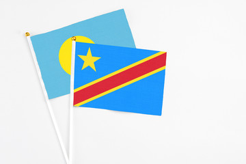 Congo and Palau stick flags on white background. High quality fabric, miniature national flag. Peaceful global concept.White floor for copy space.