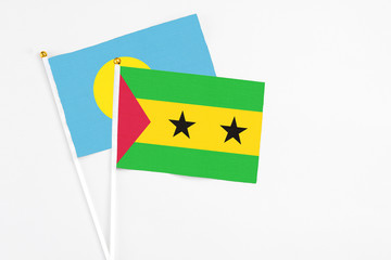 Sao Tome And Principe and Palau stick flags on white background. High quality fabric, miniature national flag. Peaceful global concept.White floor for copy space.