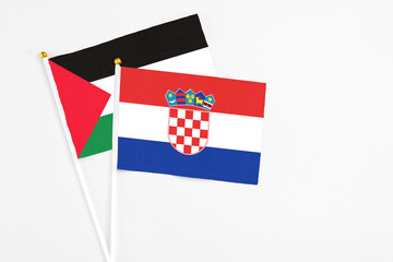 Croatia and Palestine stick flags on white background. High quality fabric, miniature national...