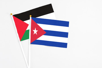 Cuba and Palestine stick flags on white background. High quality fabric, miniature national flag. Peaceful global concept.White floor for copy space.