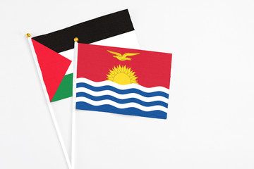 Kiribati and Palestine stick flags on white background. High quality fabric, miniature national flag. Peaceful global concept.White floor for copy space.