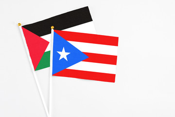 Puerto Rico and Palestine stick flags on white background. High quality fabric, miniature national flag. Peaceful global concept.White floor for copy space.