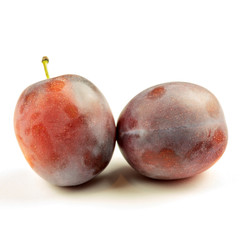 Fresh ripe purple plum on the white background closeup.