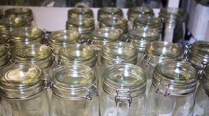 Glass jar lids with metal locks. Selective focus. Home inventory, design, structures.