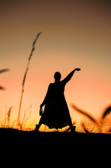 silhouette of a girl dancing on the background of a beautiful sunset