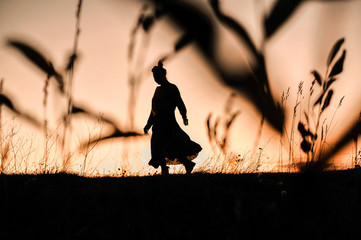 silhouette of a girl dancing on the background of a beautiful sunset