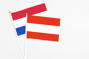 Austria and Paraguay stick flags on white background. High quality fabric, miniature national flag. Peaceful global concept.White floor for copy space.