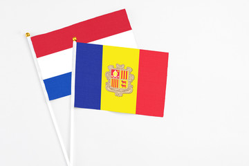Andorra and Paraguay stick flags on white background. High quality fabric, miniature national flag. Peaceful global concept.White floor for copy space.