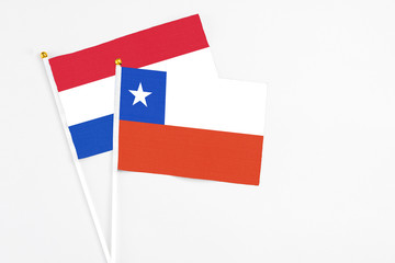 Chile and Paraguay stick flags on white background. High quality fabric, miniature national flag. Peaceful global concept.White floor for copy space.