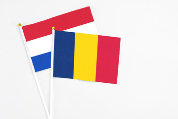 Chad and Paraguay stick flags on white background. High quality fabric, miniature national flag....