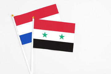 Syria and Paraguay stick flags on white background. High quality fabric, miniature national flag....