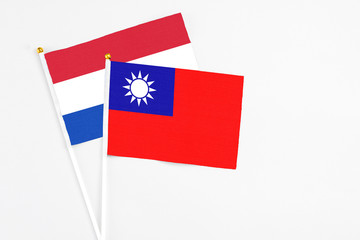 Taiwan and Paraguay stick flags on white background. High quality fabric, miniature national flag. Peaceful global concept.White floor for copy space.