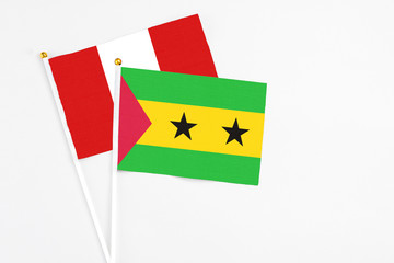 Sao Tome And Principe and Peru stick flags on white background. High quality fabric, miniature national flag. Peaceful global concept.White floor for copy space.