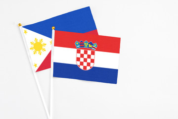 Croatia and Philippines stick flags on white background. High quality fabric, miniature national...