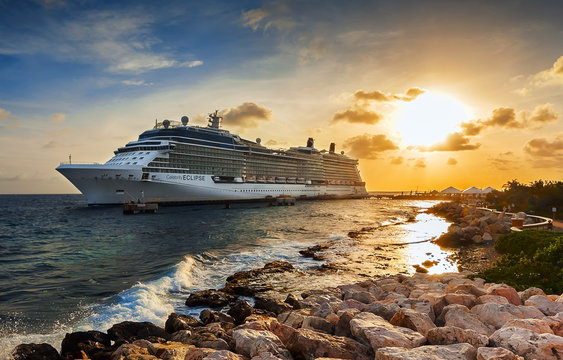 WILLEMSTAD, CURACAO - APRIL 10, 2018:  Cruise ship Celebrity Eclipse docked at port Willemstad on sunset. The island is a popular Caribbean cruise destination