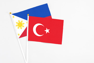 Turkey and Philippines stick flags on white background. High quality fabric, miniature national flag. Peaceful global concept.White floor for copy space.