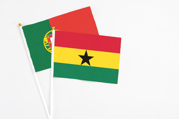 Ghana and Portugal stick flags on white background. High quality fabric, miniature national flag. Peaceful global concept.White floor for copy space.
