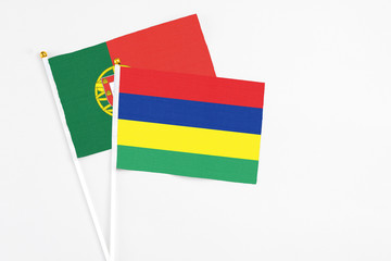 Mauritius and Portugal stick flags on white background. High quality fabric, miniature national flag. Peaceful global concept.White floor for copy space.