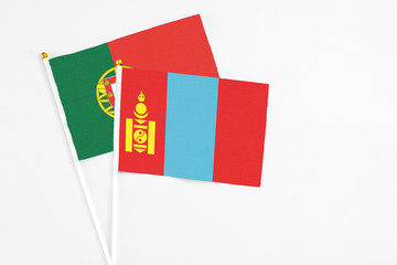 Mongolia and Portugal stick flags on white background. High quality fabric, miniature national flag. Peaceful global concept.White floor for copy space.