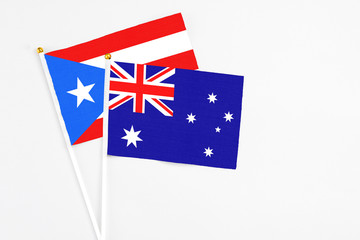 Fototapeta premium Australia and Puerto Rico stick flags on white background. High quality fabric, miniature national flag. Peaceful global concept.White floor for copy space.